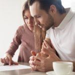 Couple looking at car warranty contract